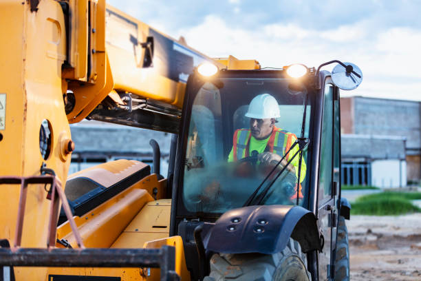 istock Construction worker operating heavy machinery at jobsite 1907137160