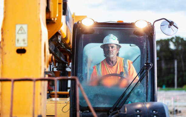istock Construction worker operating heavy machinery at job site 1907137658