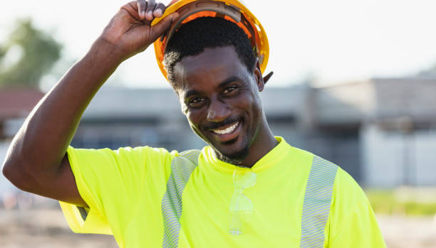 istock African-American construction worker putting on hardhat 1907139334