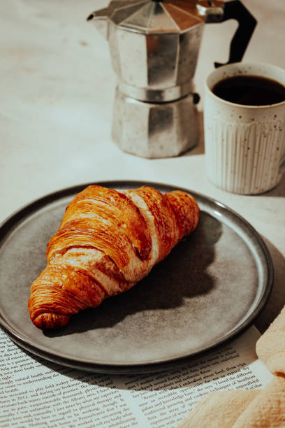 istock Croissant on a blue plate with coffee 1907139350