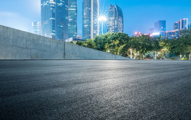 istock Empty asphalt road and cityscape at night 1907145789