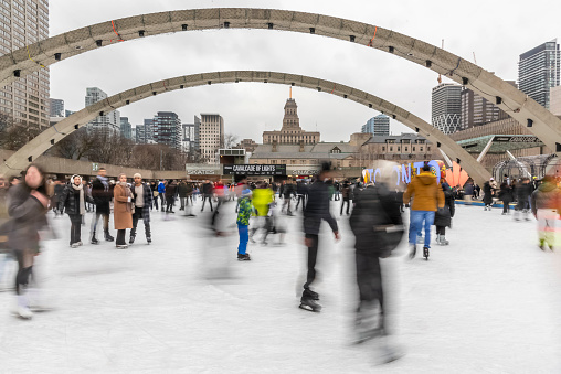 Toronto Ontario, Canada-January 3rd, 2024: People on the ice at Toronto City Hall’s Nathan Phillips Square.