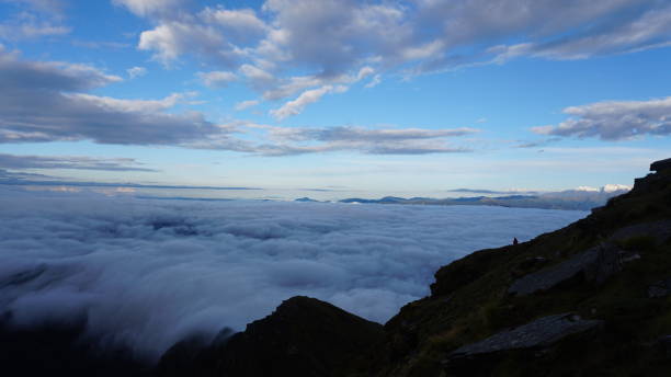istock a rocky outcrop with some people in the clouds, 
Chandrashila peak 1907163380