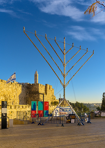 Jerusalem Israel 12/16/2023 Huge Hanukkiah against the backdrop of the walls of the old city and the Tower of David