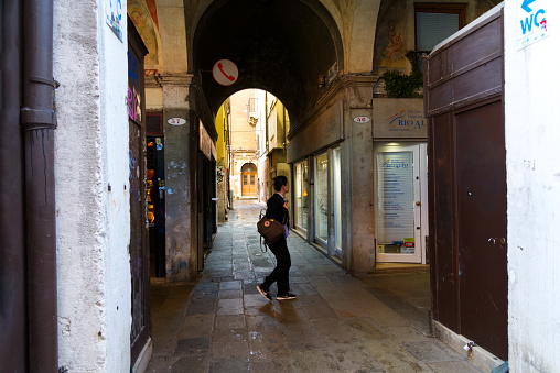 Adult Italian woman walking in the streets of her city in Italy.