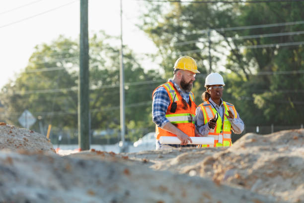 istock Female construction worker with coworker at job site 1907187988