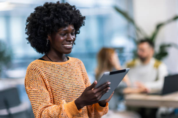 istock Business woman standing in her office with his tablet. 1907188525