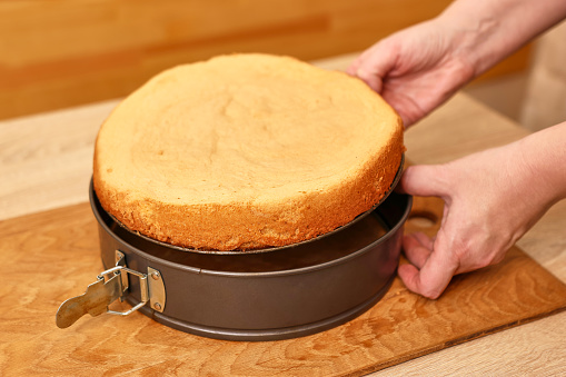 The freshly baked cake is removed from the mold. Cooking a festive pie at home