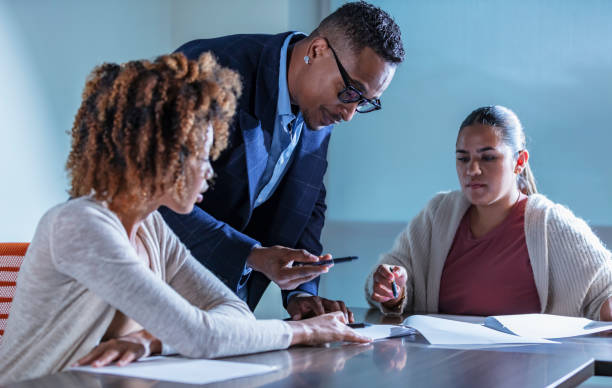 istock Multiracial business people in meeting reading papers 1907226810
