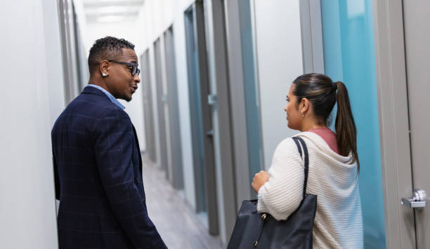 istock Multiracial business people walk in office hallway 1907227896