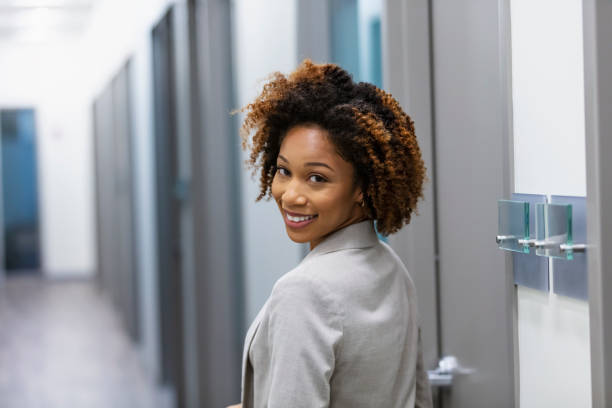 istock African-American businesswoman walking down hallway 1907228428