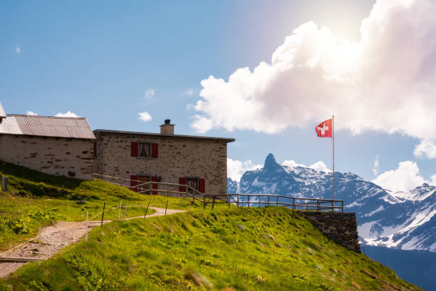 istock Beautiful mountain summer landscape with Swiss flag 1907249102