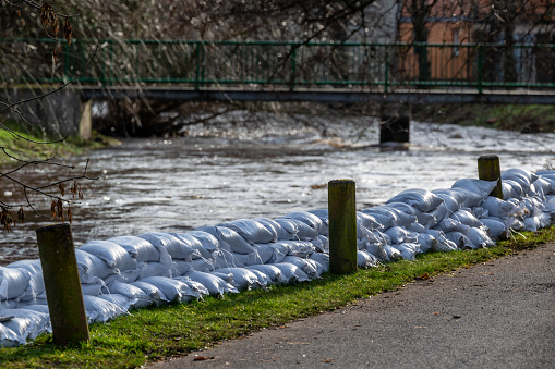 Sandbags on river banks are intended to protect against flooding