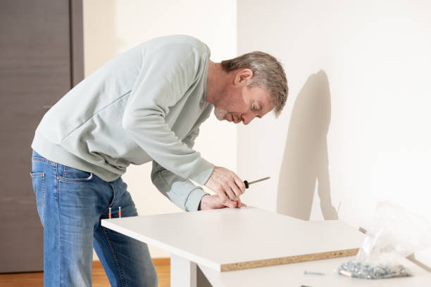istock A 50-year-old man assembles flat-pack furniture 1907267124