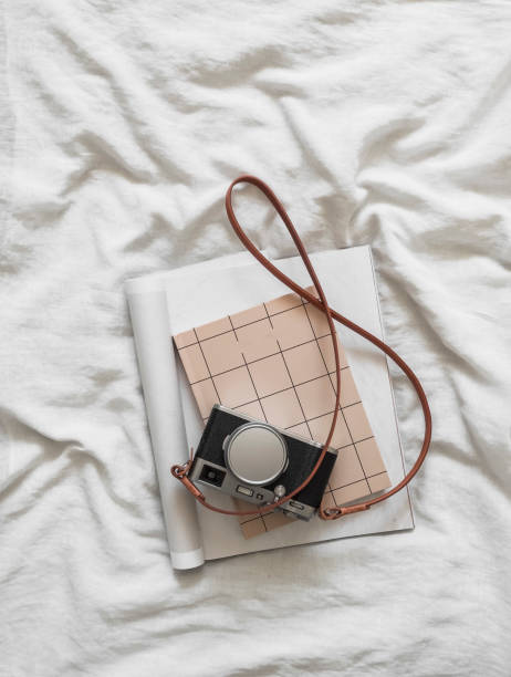 istock Retro camera, magazine, notebook - aesthetics accessories on white sheets , top view 1907293876