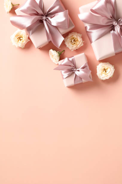 istock Happy Valentine's Day concept. Vertical banner template with gift boxes and flowers on peach color color background. 1907306494