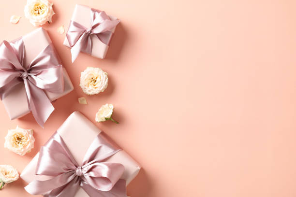 istock Happy Valentines Day flat lay composition with gift boxes and flowers on peach color color background. 1907308063