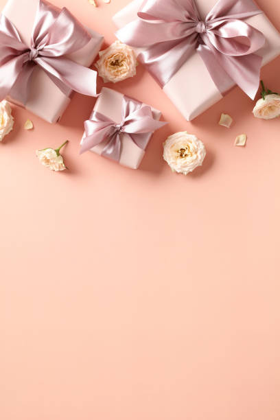 istock Happy Valentine's Day vertical banner design. Flat lay gift boxes, heart shaped candles, flowers on peach color color background. Flat lay, top view. 1907310139