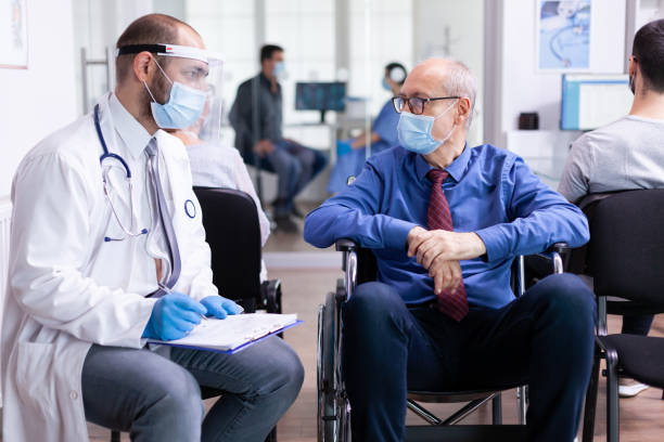 istock Doctor consulting disabled senior man 1907312984