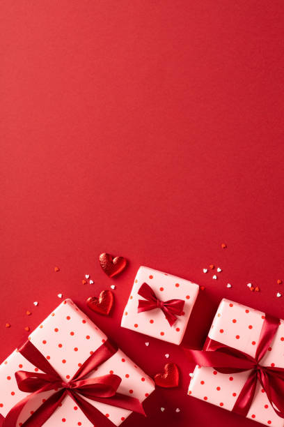 istock Valentine's Day gift box with hearts on red background. 1907324507