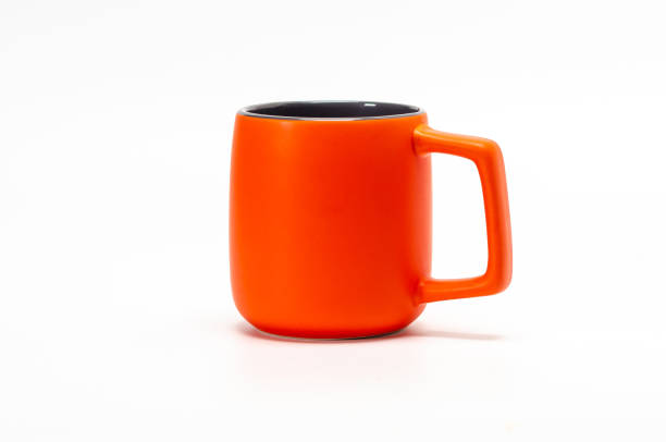 istock Large orange ceramic mug isolated on white background. This is a clipping path. 1907324545