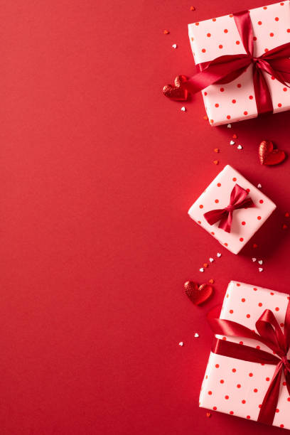 istock Valentine's day vertical banner design. Gift boxes with hearts on red background. Love, romance concept. 1907328226