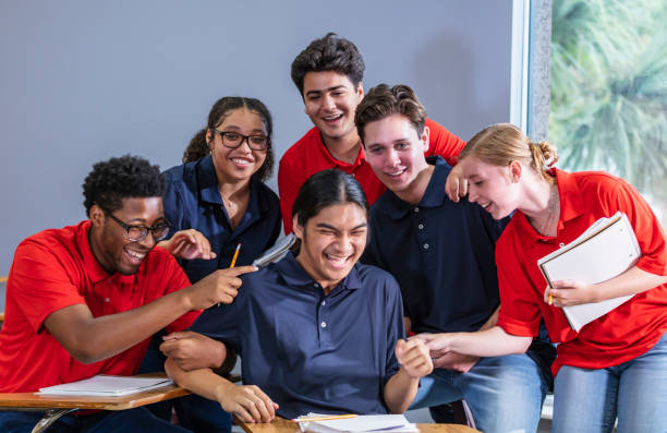 istock Group of multiracial high school students laugh in class 1907343131