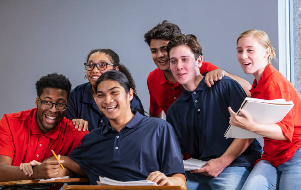 istock Group of multiracial high school students in classroom 1907343132