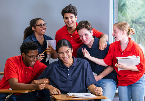 istock Group of multiracial high school students in classroom 1907343140