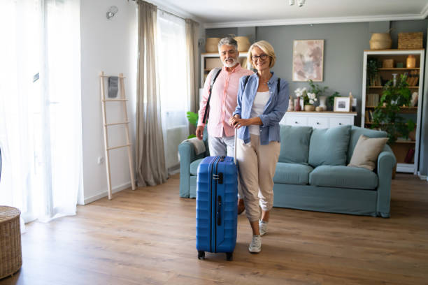 istock Senior Couple Standing With Suitcase About To Leave For Vacation 1907345245
