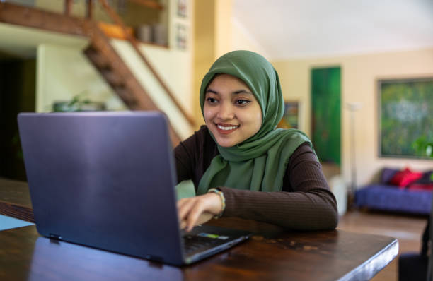istock A close up of a young muslim student with a hijab using a laptop 1907347377