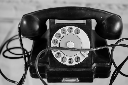 Old black telephone. Rotary Dial. The cable.