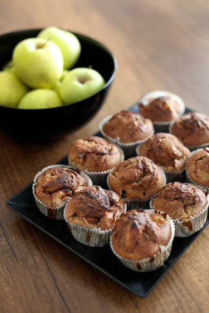 Group of delicious homemade muffins on a wooden table.