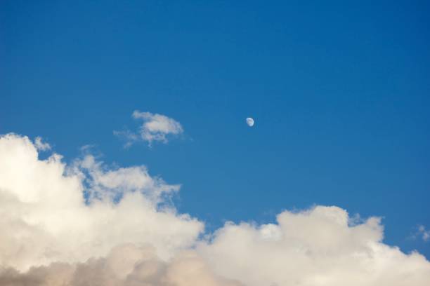 istock The moon and the fluffy white clouds in a blue sky 1907381672