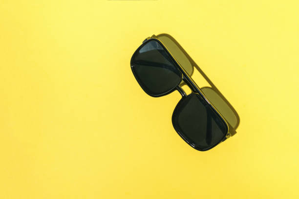 istock Classic sunglasses on a yellow background. 1907381972