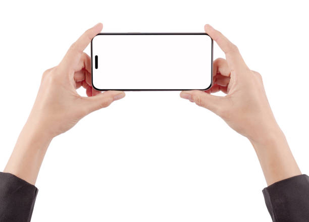 istock Woman's hand holding a phone is using her hand to touch the screen on a white background. 1907382063