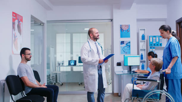 istock Young doctor talking with disabled woman 1907403538