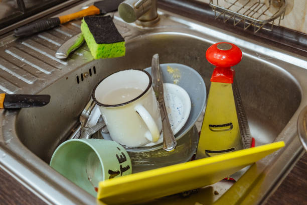 istock dirty dishes in sink 1907422075