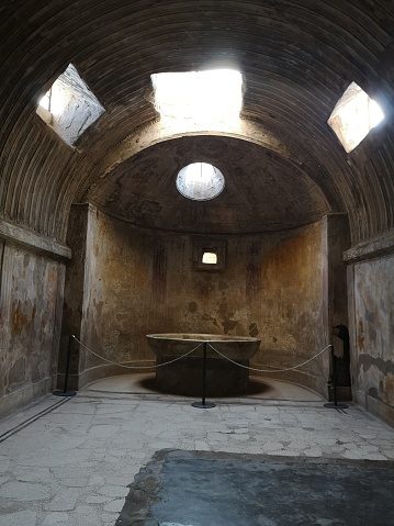 Light enters through the oculus of the Frigidarium in the Baths of the Forum of Pompeii