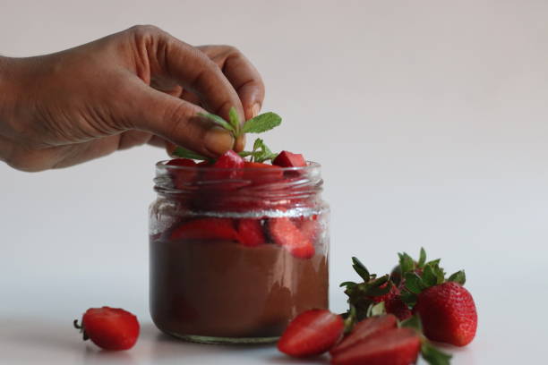 istock Chocolate strawberry custard. Chocolate custard served with fresh chopped strawberries. A quick and easy dessert 1907446543