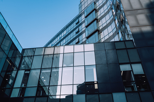 Low angle view of futuristic architecture, Skyscraper office building with cloud reflected on window, 3D rendering.