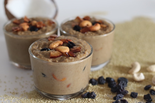 Brown top millet payasam. Pudding or Kheer or payasam made of brown top millet, jaggery and coconut milk, flavored with cardamom. Topped with raisins, ghee fried cashews and coconut pieces.