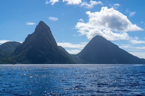 A photo of the Twin Pitons in St Lucia on a sunny day as seen from the Caribbean Sea.