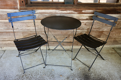 Black bistro table with two chairs