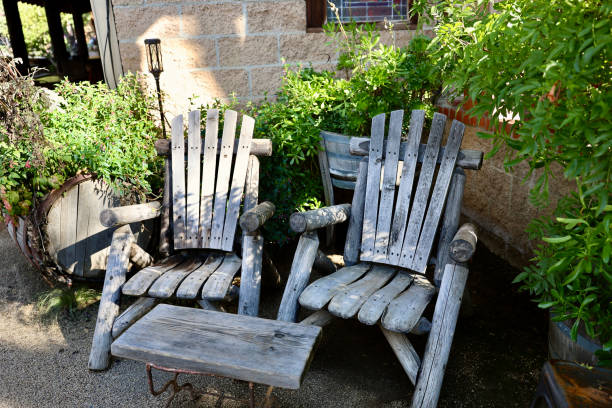 istock Old fashioned Adirondack chairs in the garden 1907493170