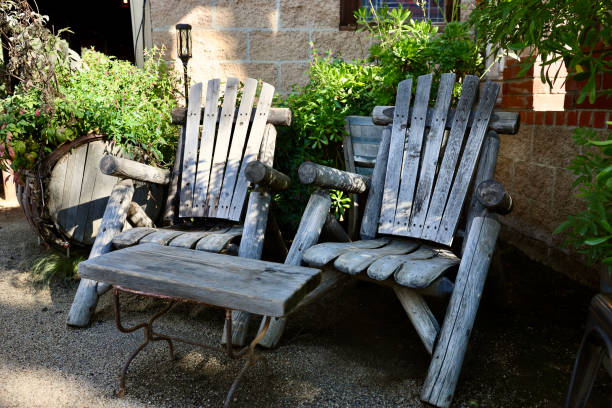 istock Old fashioned Adirondack chairs in the garden 1907493171
