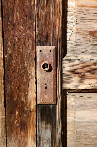 Broken rusty metal doorknob with old fashioned keyhole