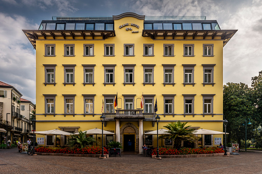 Riva del Garda, Italy - October, 04. 2023: Town square downtown Riva del Garda with Grand Hotel Riva.
