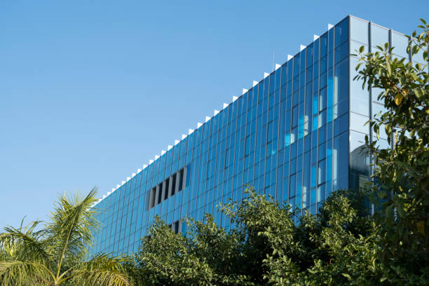 istock Sunlight shining on the glass of office building 1907546303