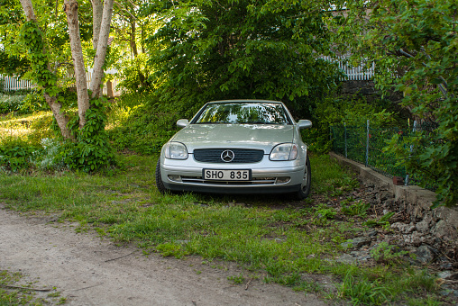 Gothenburg, Sweden - June 06 2007: Silver 1999 Mercedes Benz SLK 230 Kompressor parked by the side of a road.
